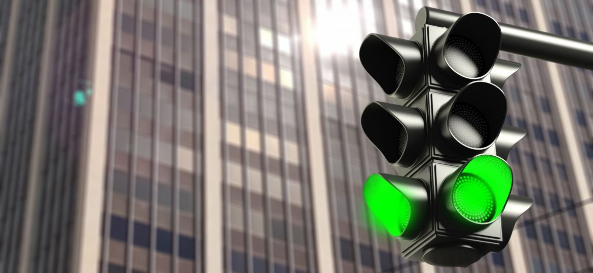 Green traffic lights on office building background, copy space. 3d illustration