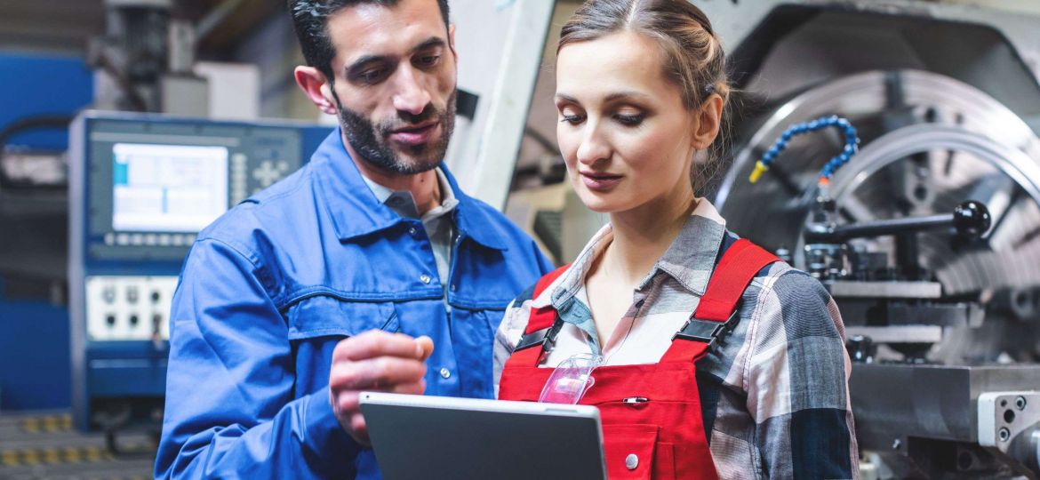 Woman and man manufacturing worker in discussion